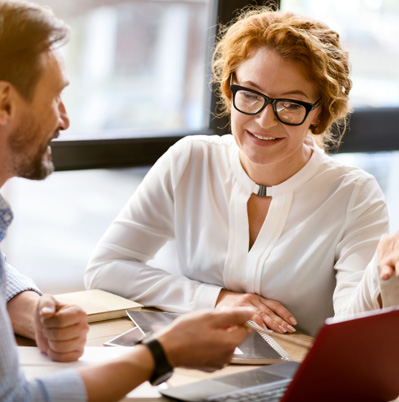 Image of two staff talking